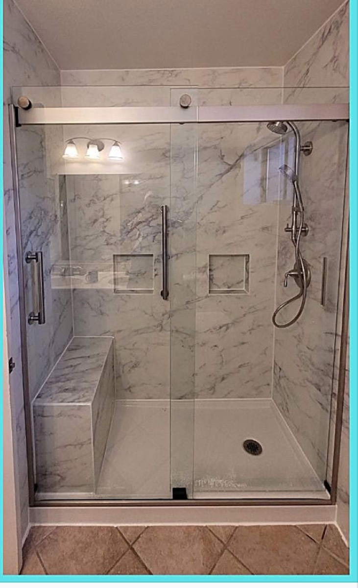 Bathroom after remodel — marble-look tile shower with glass door
