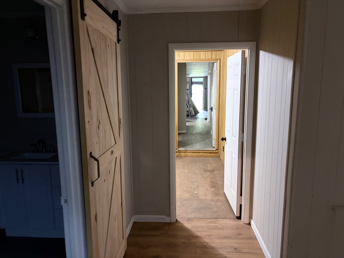 Commercial interior after renovation — finished hallway with barn door