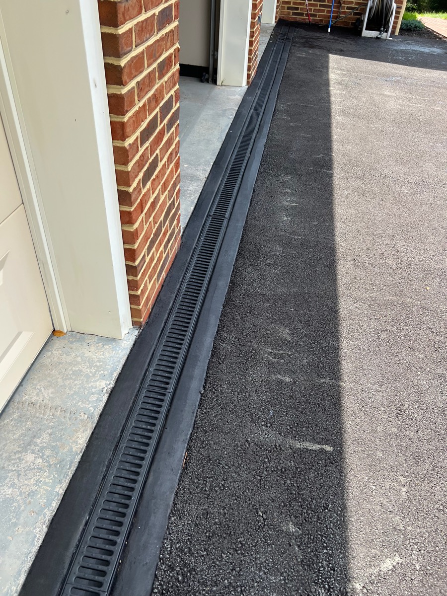 Driveway after — finished channel drain set in new concrete
